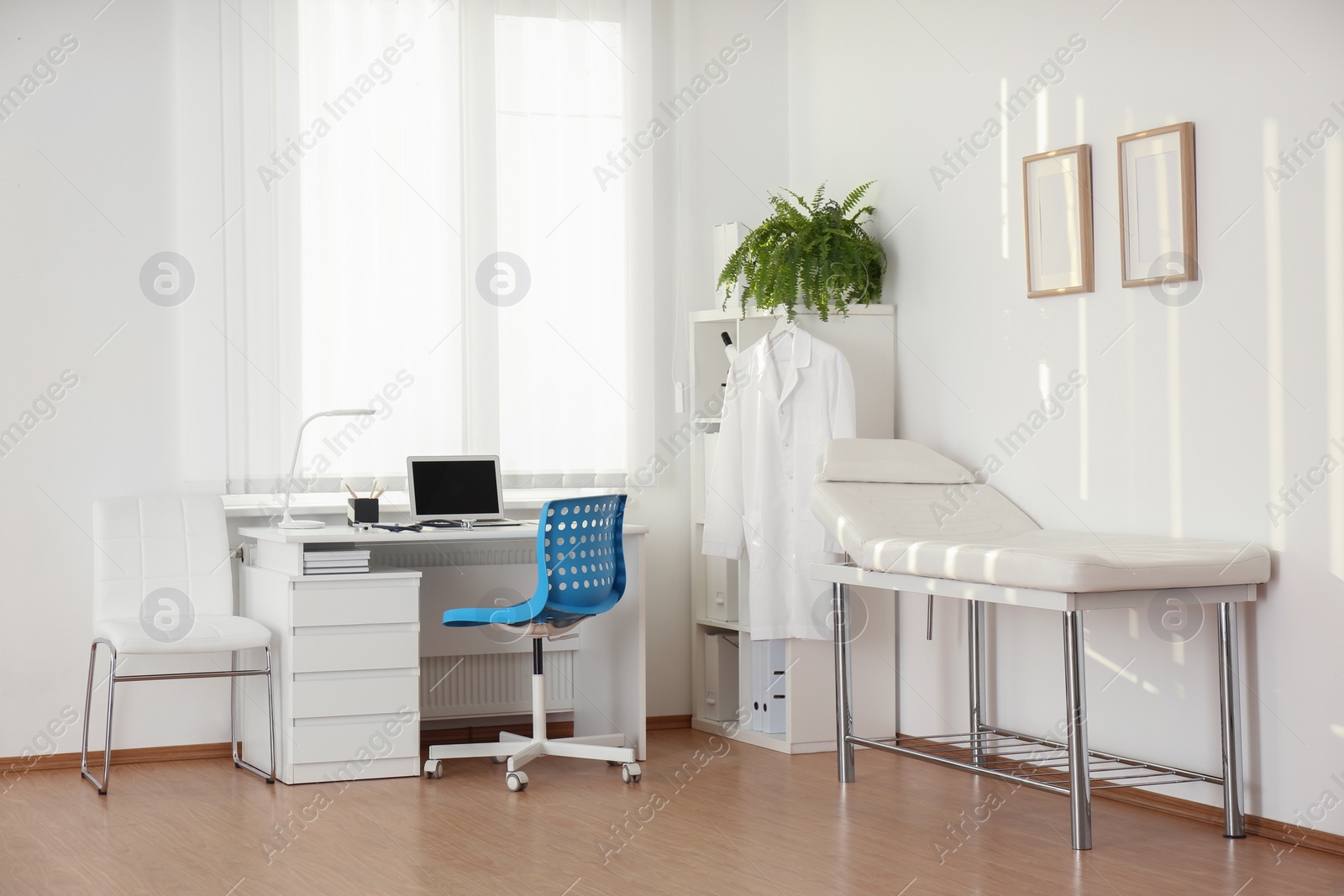 Photo of Interior of modern medical office with doctor's workplace