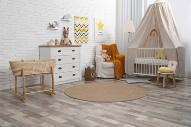Photo of Stylish baby's room with comfortable cot. Interior design
