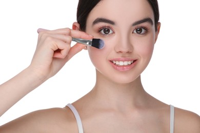 Photo of Teenage girl with makeup brush on white background