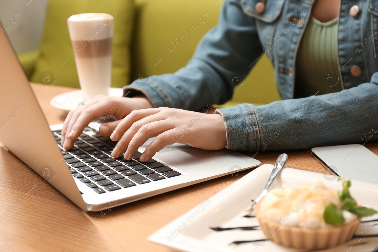 Photo of Blogger working with laptop in cafe, closeup