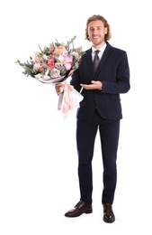 Photo of Young handsome man in stylish suit with beautiful flower bouquet on white background