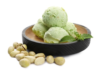 Photo of Plate of delicious pistachio ice cream and nuts on white background