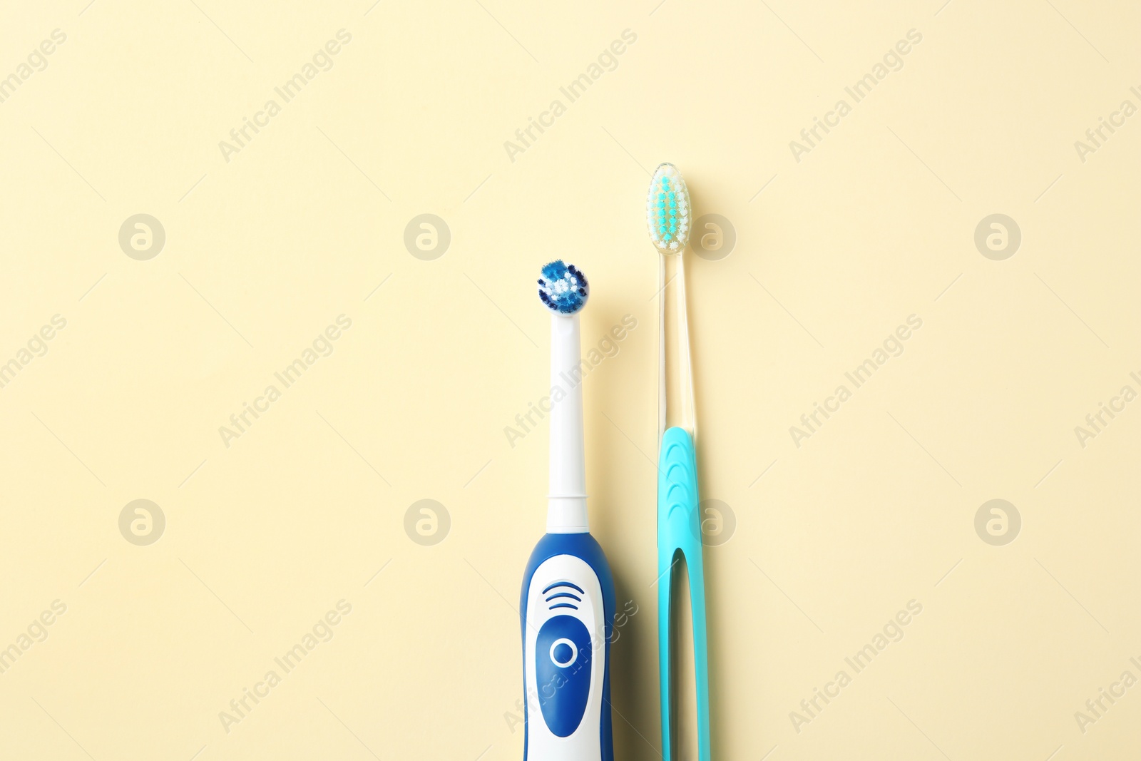 Photo of Manual and electric toothbrushes on color background. Dental care