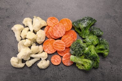 Photo of Different frozen vegetables on grey table, flat lay