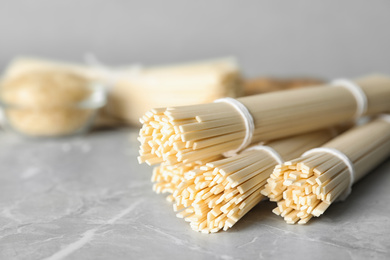 Raw rice noodles on light grey marble table