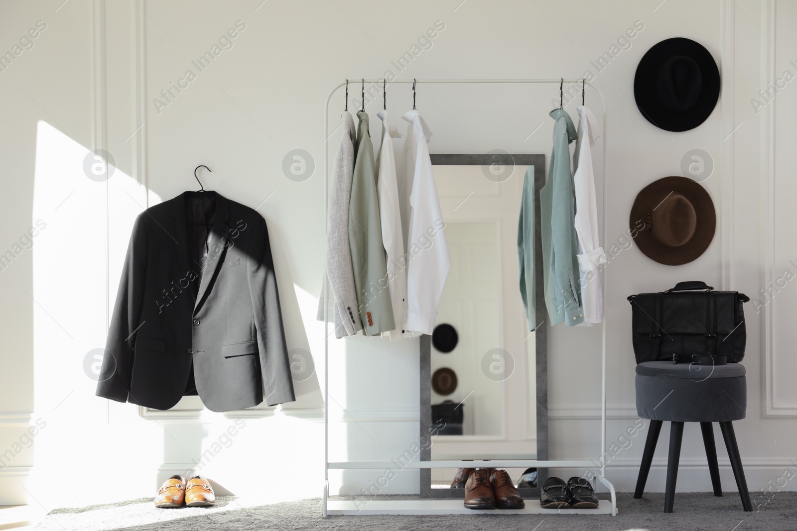 Photo of Rack with stylish clothes in modern dressing room