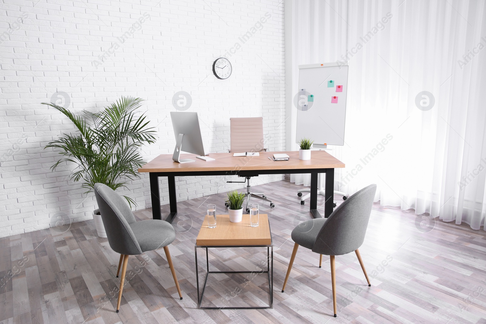 Photo of Interior of modern office with table, chairs and computer