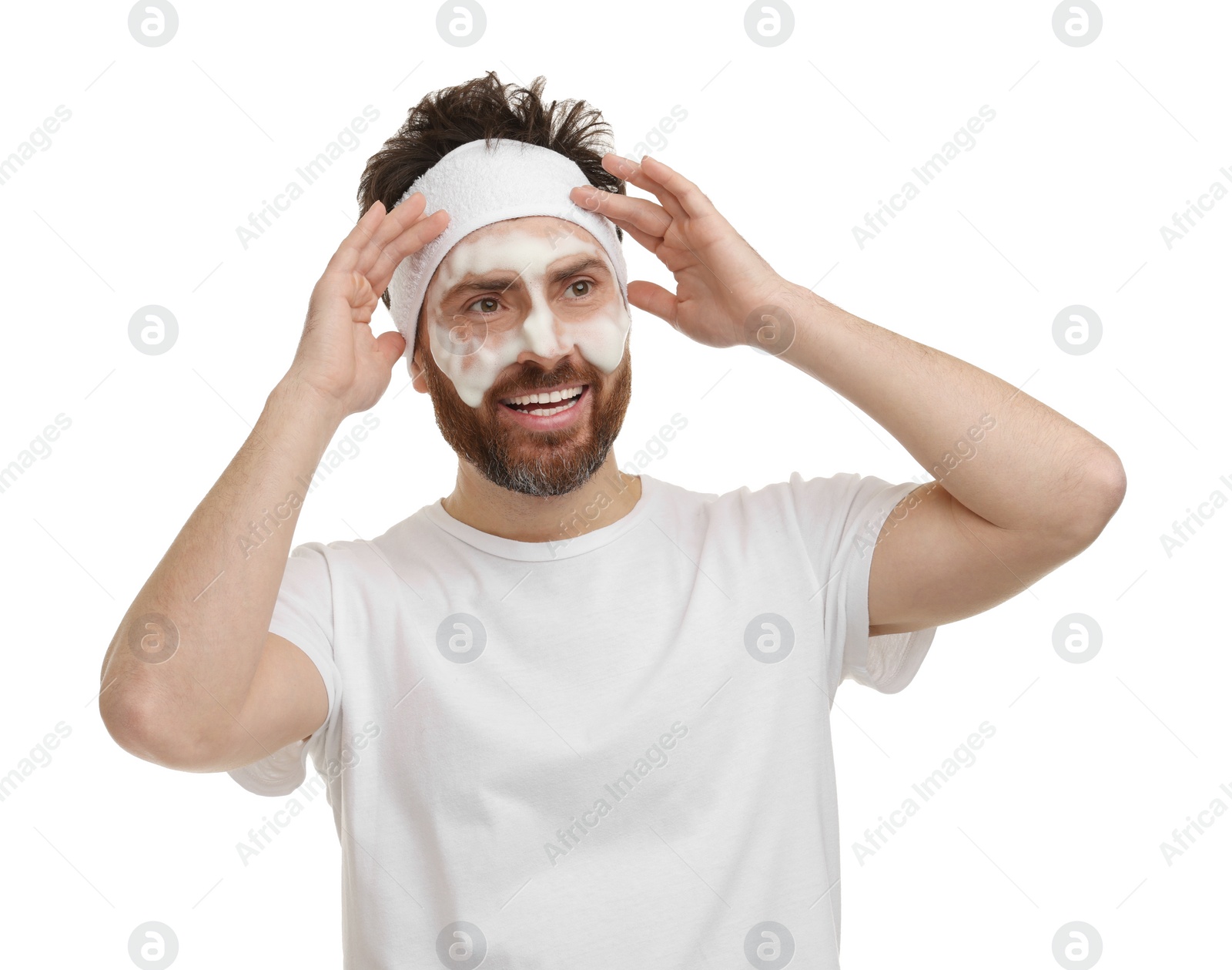 Photo of Emotional man with headband washing his face on white background