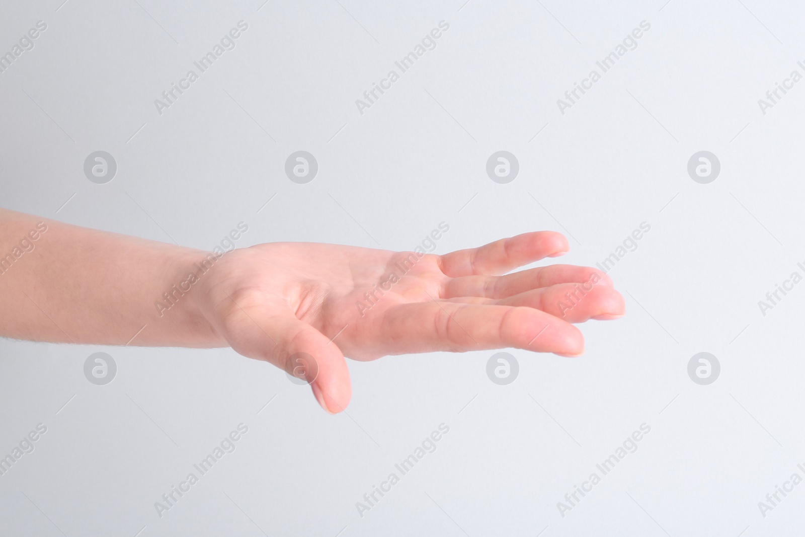 Photo of Woman holding hand on white background, closeup