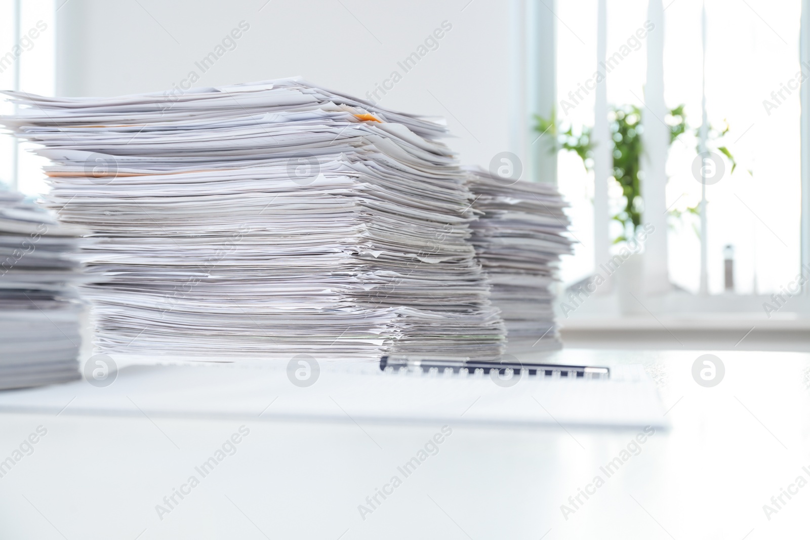 Photo of Stacks of documents on table in office