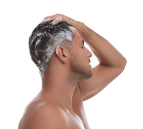 Photo of Handsome man washing hair on white background