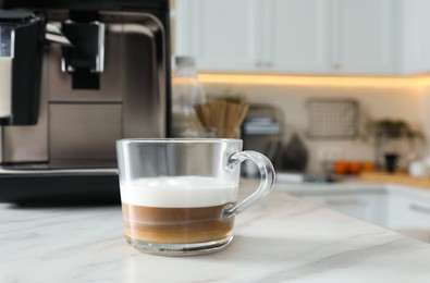 Photo of Modern coffee machine in kitchen, focus on cup. Space for text