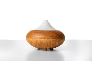 Photo of Aroma oil diffuser lamp on white background