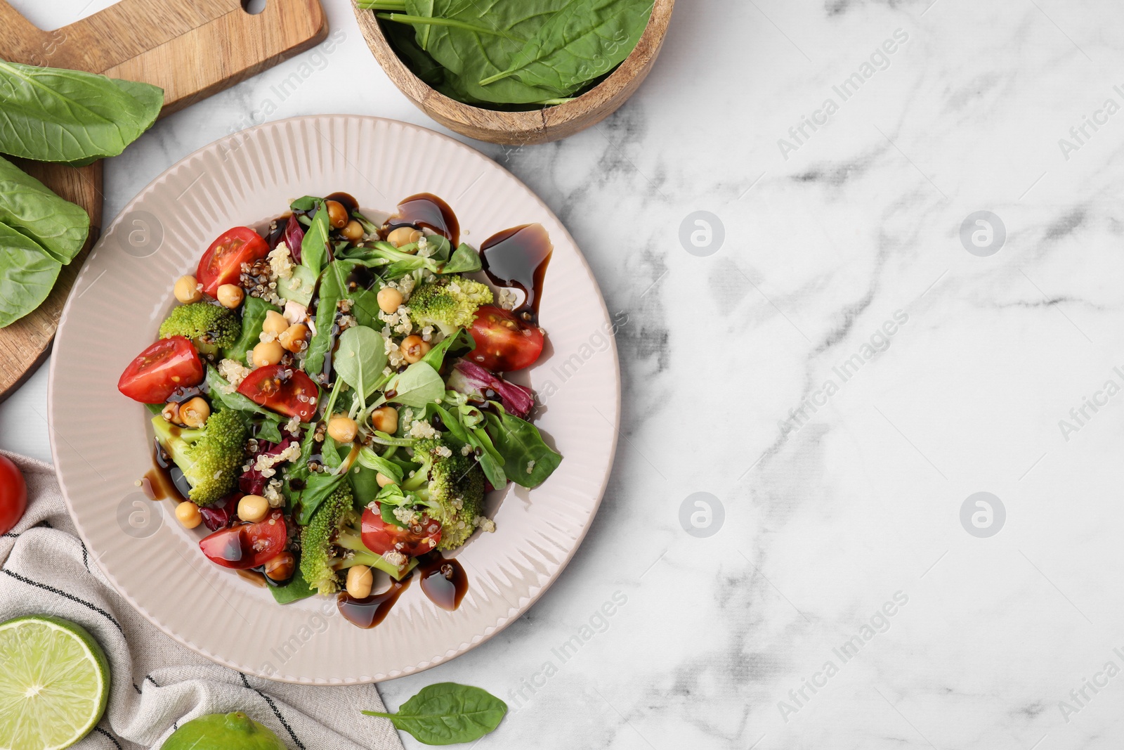 Photo of Tasty salad with balsamic vinegar on white marble table, flat lay. Space for text