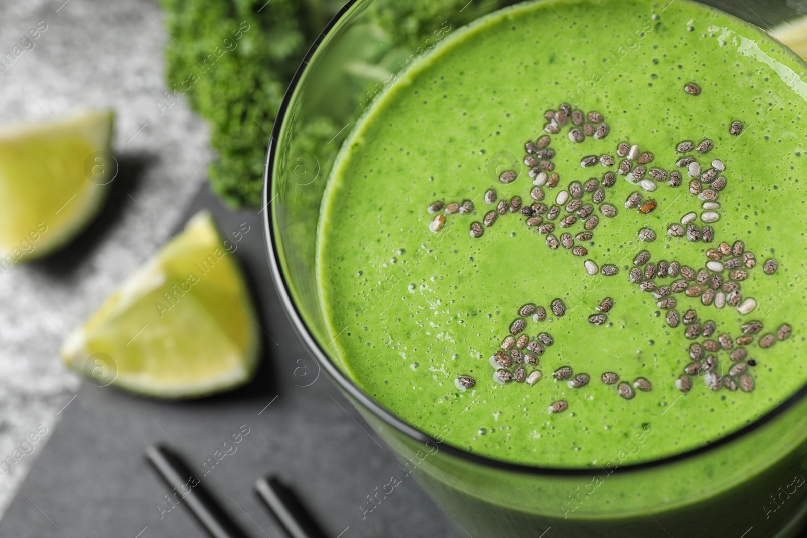 Photo of Tasty kale smoothie with chia seeds on table, closeup