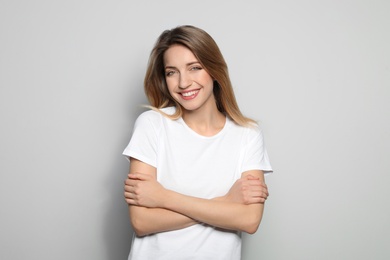 Photo of Portrait of young woman with beautiful face on grey background