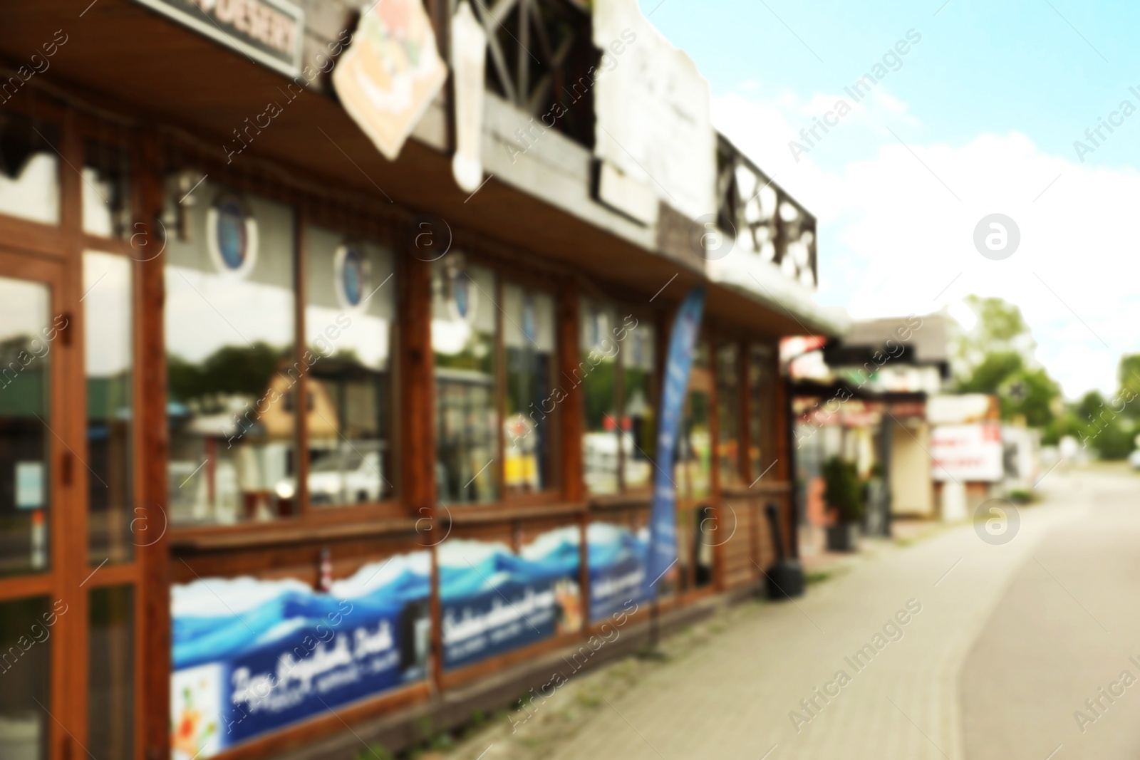 Photo of Blurred view of city street with modern store