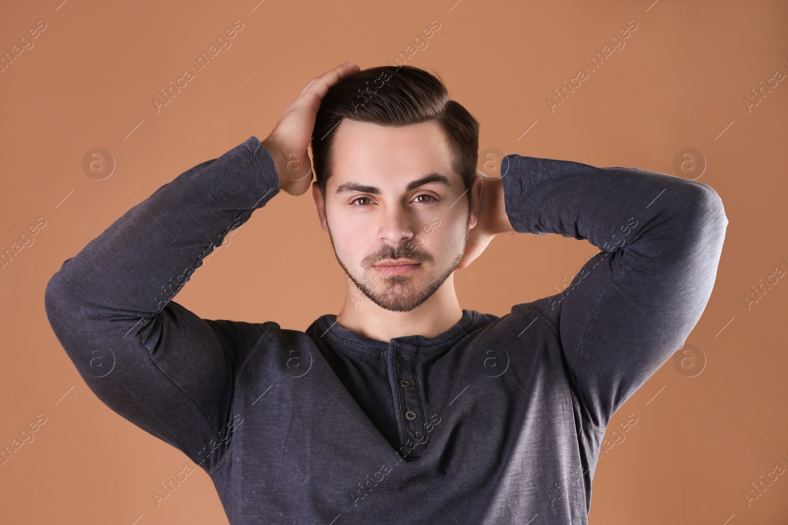 Photo of Portrait of young man with beautiful hair on color background