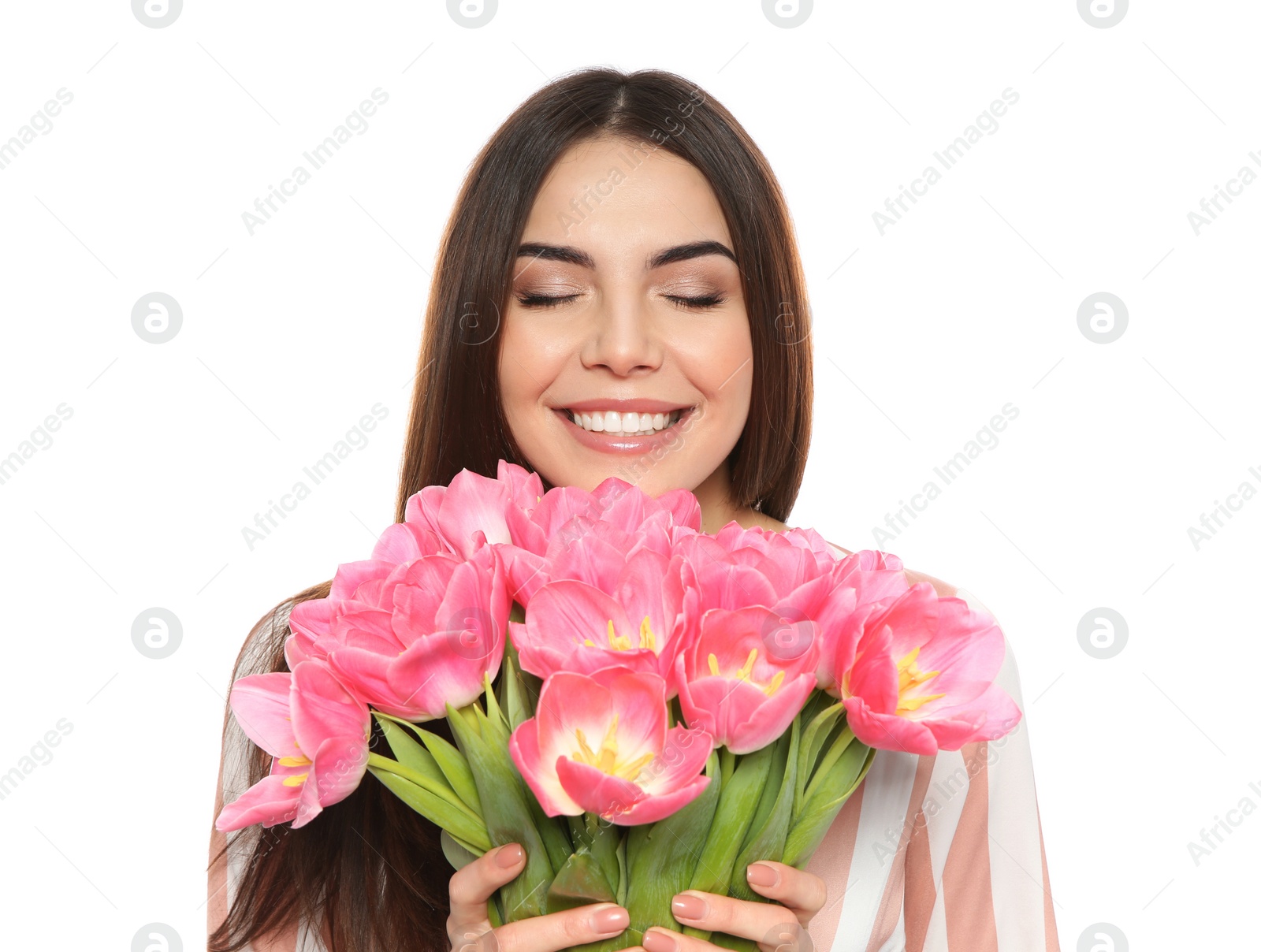 Photo of Portrait of smiling young girl with beautiful tulips on white background. International Women's Day