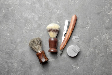 Flat lay composition with shaving accessories for men on gray background