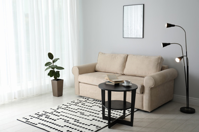 Photo of Modern comfortable sofa in stylish home interior