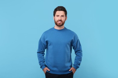 Portrait of handsome man on light blue background