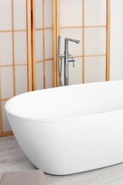 Photo of White ceramic tub in bathroom. Interior design