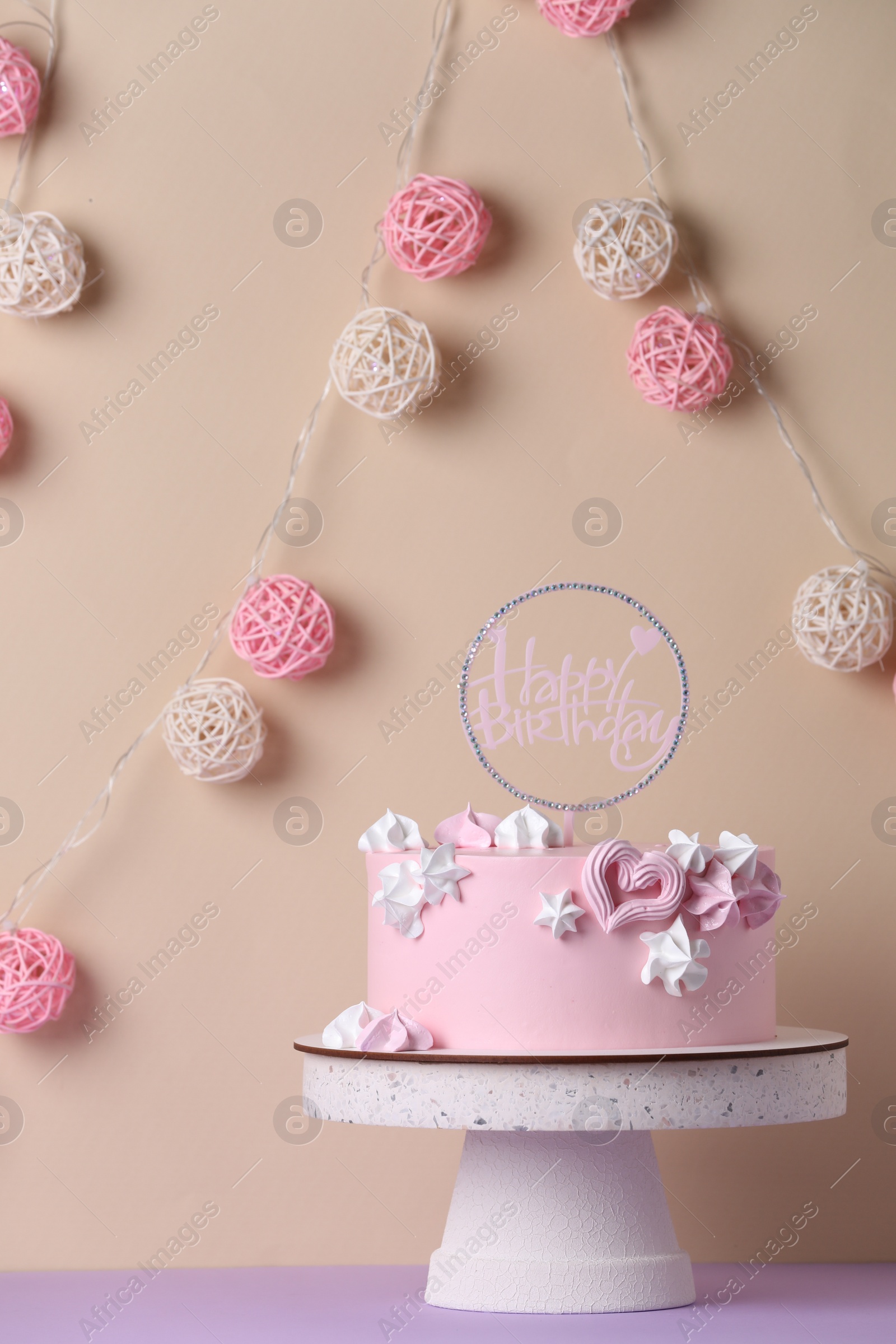 Photo of Beautifully decorated birthday cake on violet table