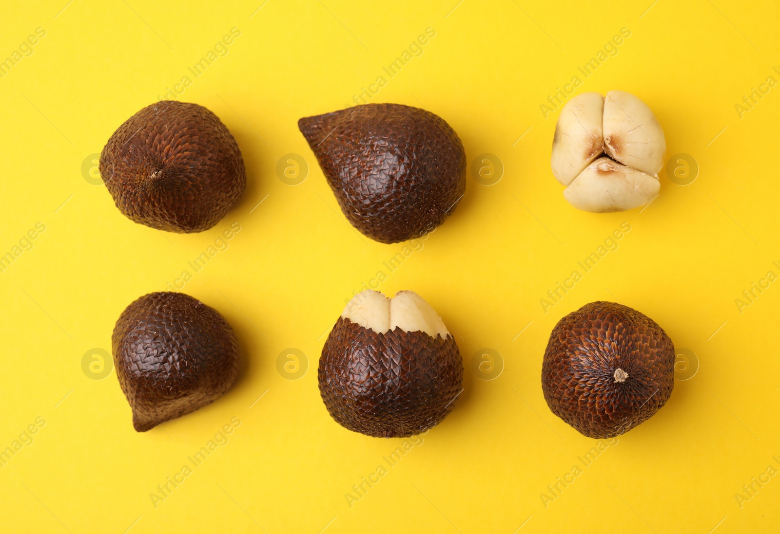 Photo of Fresh salak fruits on yellow background, flat lay