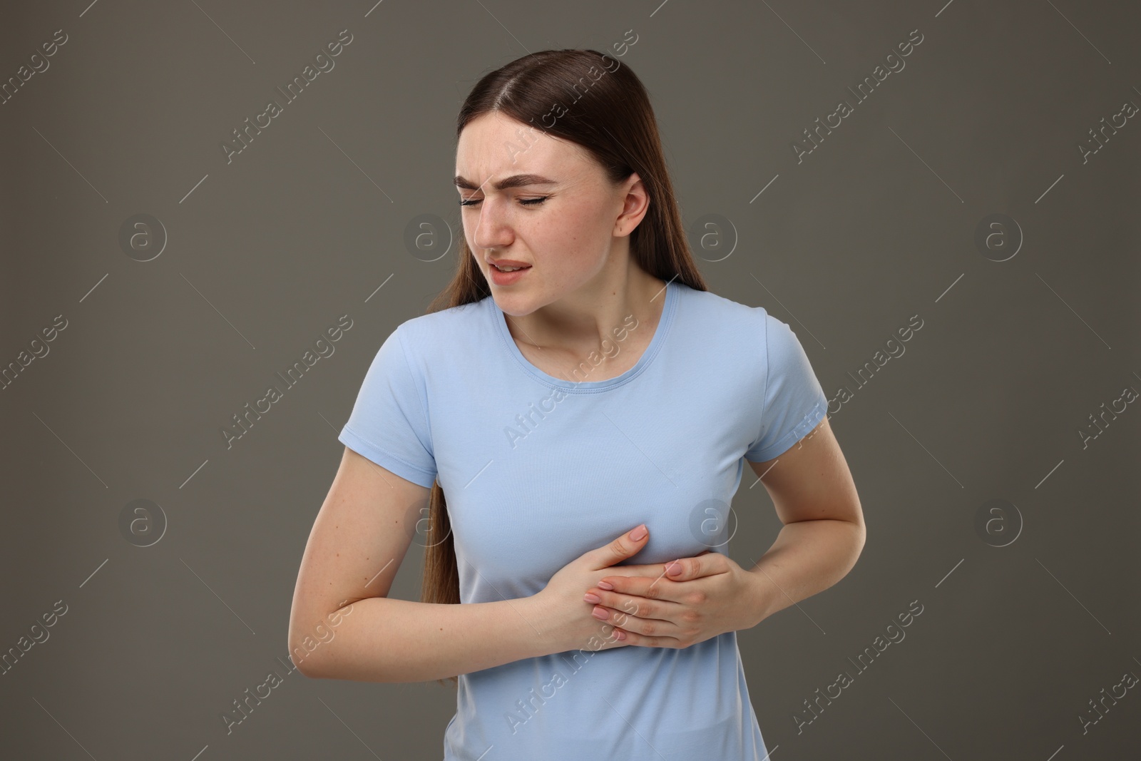 Photo of Woman having heart attack on grey background