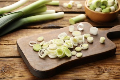 Photo of Cut fresh raw leek on wooden table