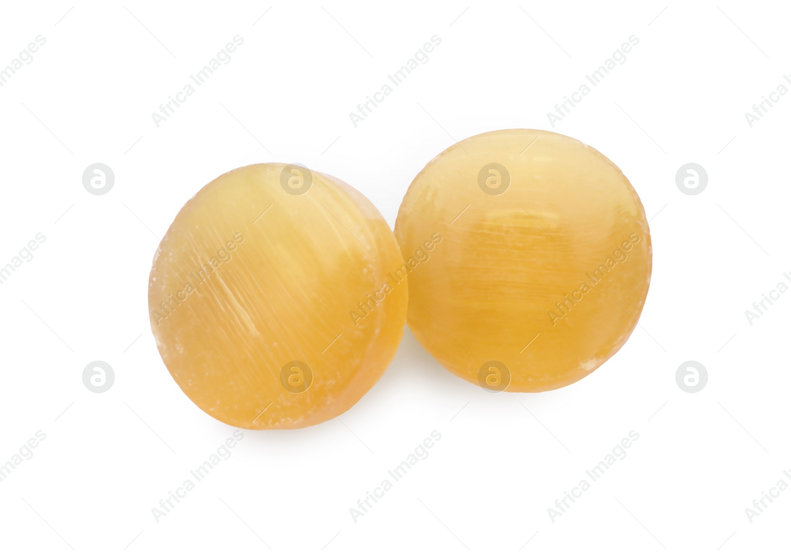 Photo of Two yellow cough drops on white background, top view