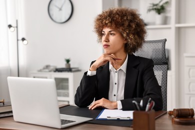 Notary with clipboard and pen at workplace in office