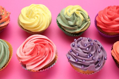 Photo of Delicious cupcake with bright cream on pink background