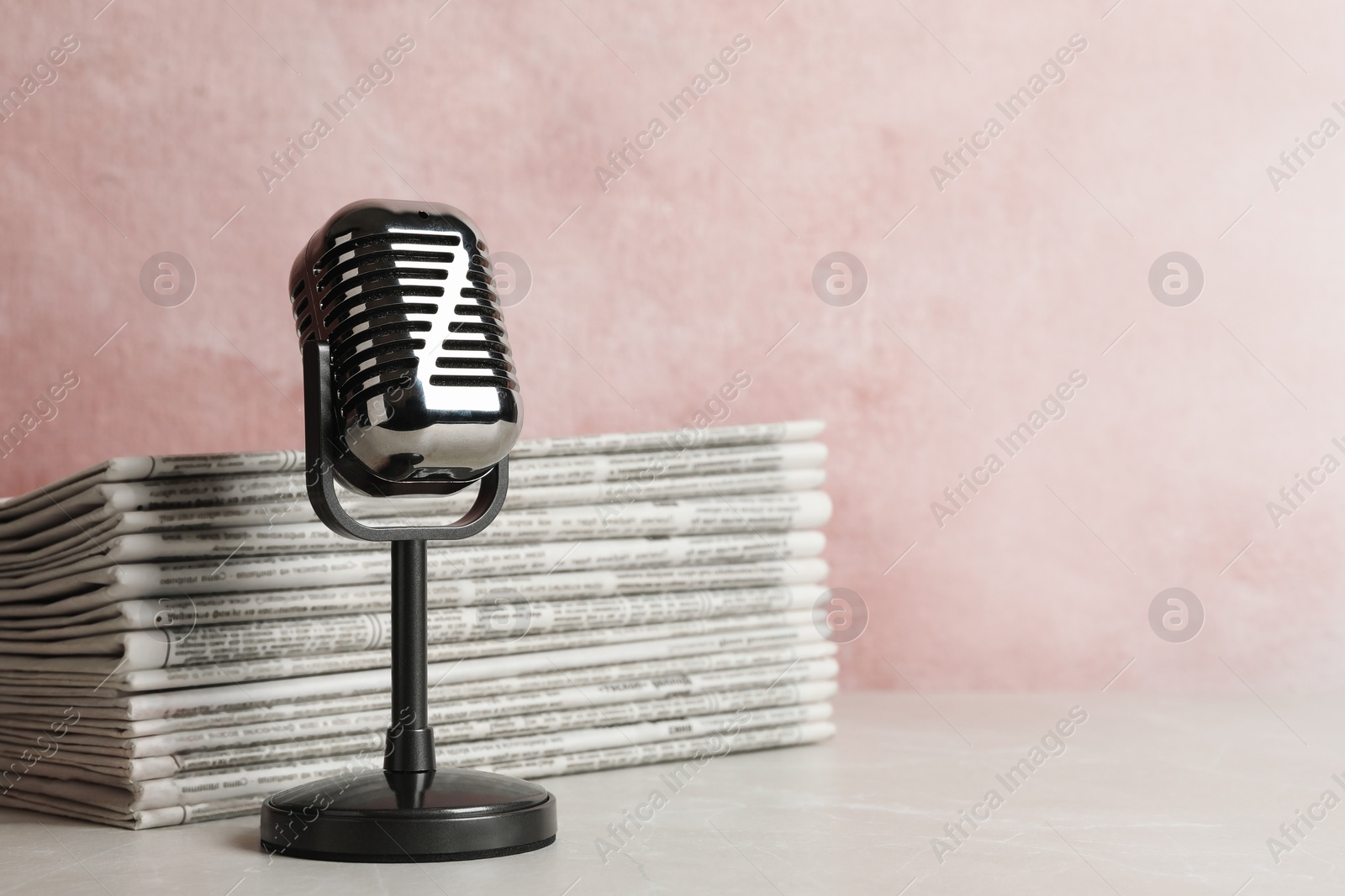 Photo of Newspapers and vintage microphone on table, space for text. Journalist's work