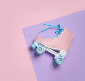 Photo of Stylish quad roller skate on color background, top view