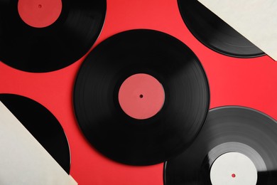 Photo of Vintage vinyl records on red background, flat lay