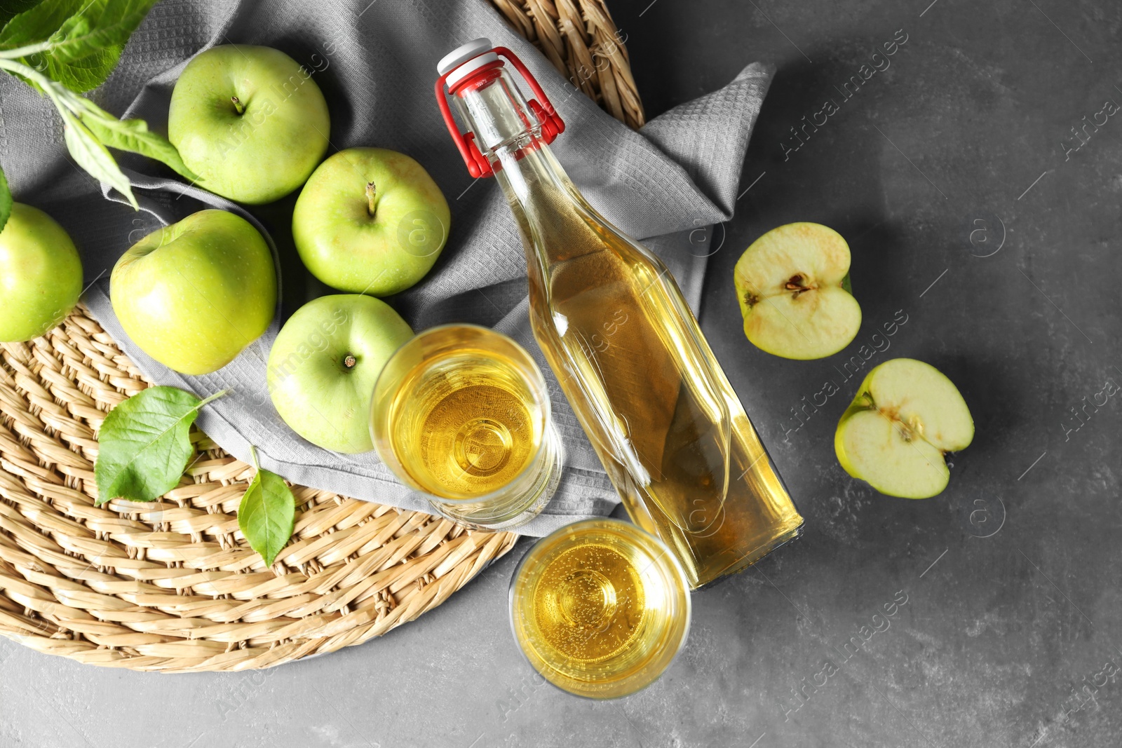 Photo of Flat lay composition with delicious apple cider on gray table