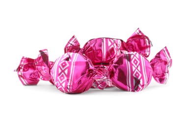 Photo of Candies in bright pink wrappers isolated on white