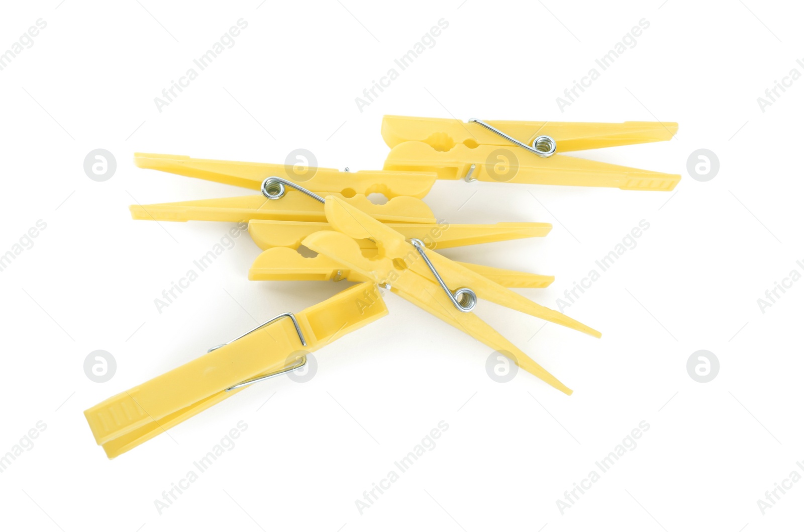 Photo of Bright yellow plastic clothespins on white background