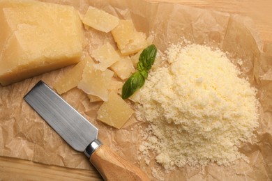 Delicious parmesan cheese on parchment paper, flat lay