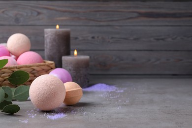 Photo of Beautiful composition with aromatic bath bombs on grey table, space for text