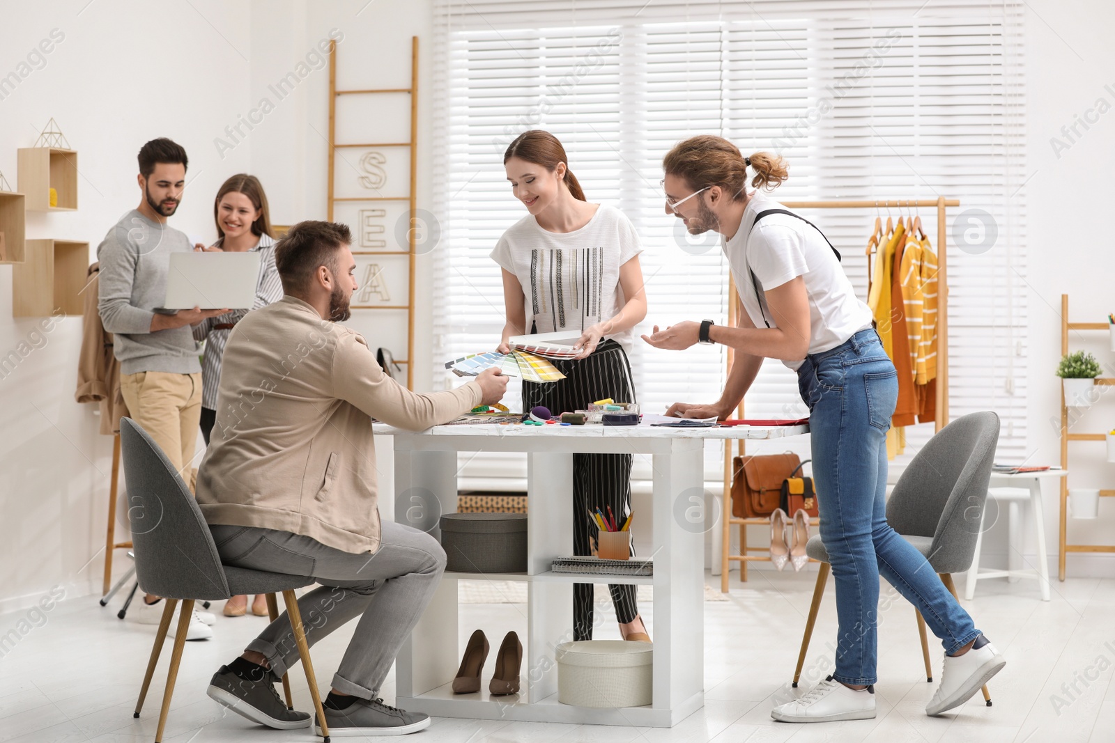 Photo of Fashion designers creating new clothes in studio