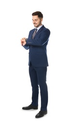 Photo of Full length portrait of businessman looking at wrist watch on white background