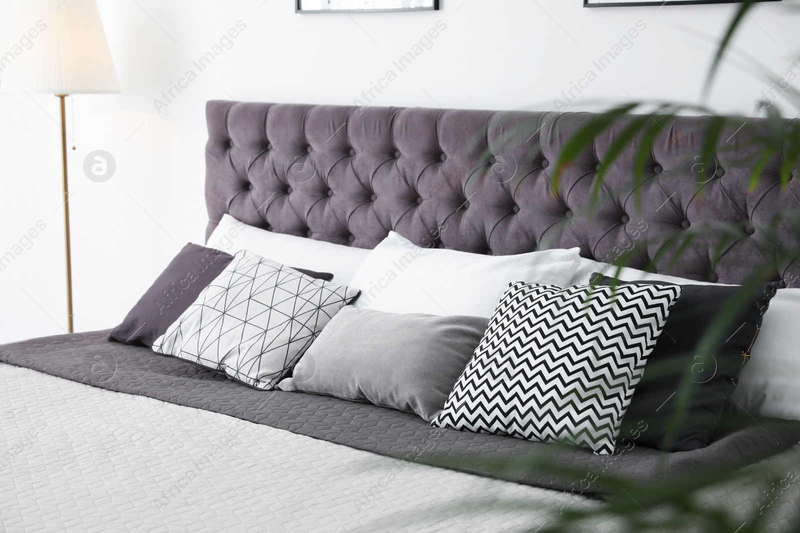 Photo of Soft pillows on modern bed in room