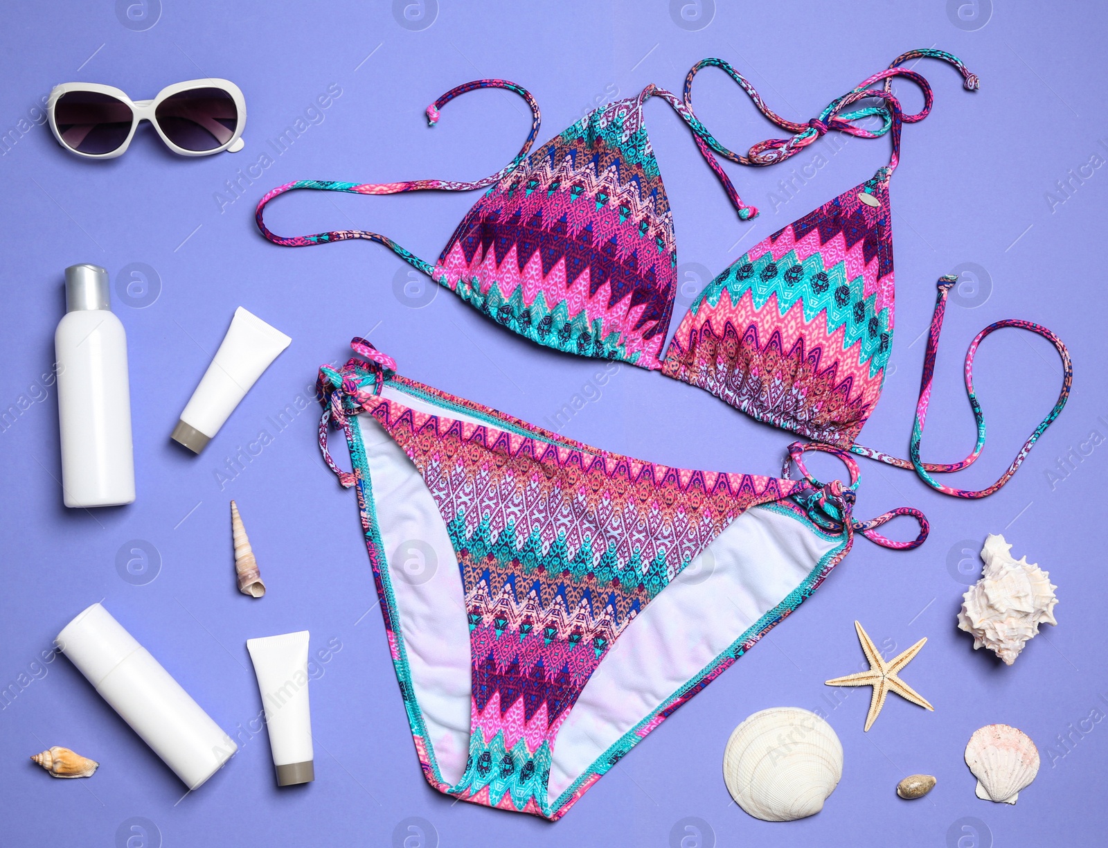 Photo of Flat lay composition with stylish bikini on color background