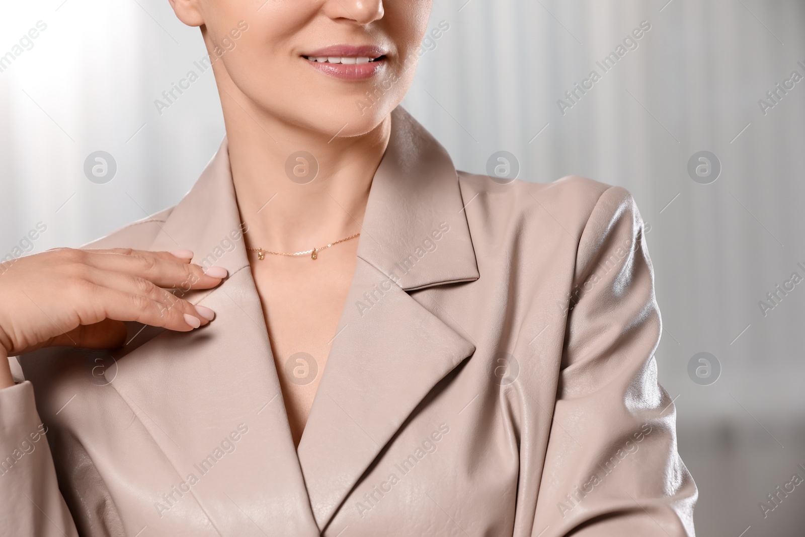 Photo of Woman with elegant necklace on blurred background, closeup