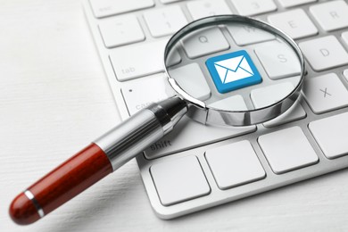 Image of Email. Light blue button with illustration of envelope on computer keyboard, view through magnifying glass, closeup