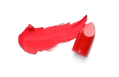 Photo of Stroke and lipstick on white background, top view