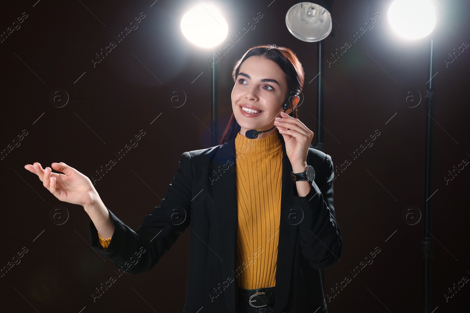 Photo of Motivational speaker with headset performing on stage